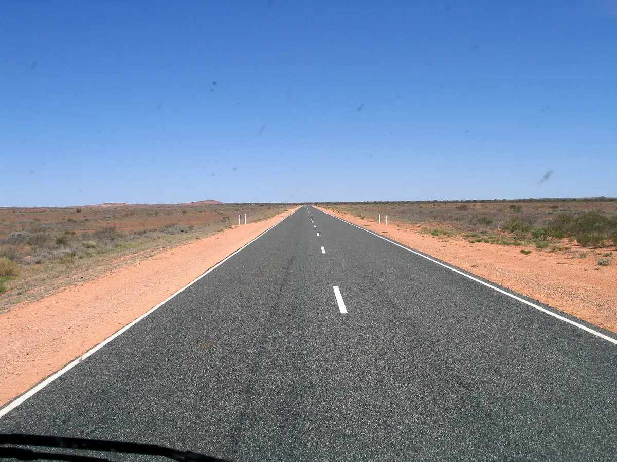 The straight Stuart Highway through red desert